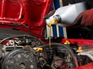 New engine oil being poured into an engine.